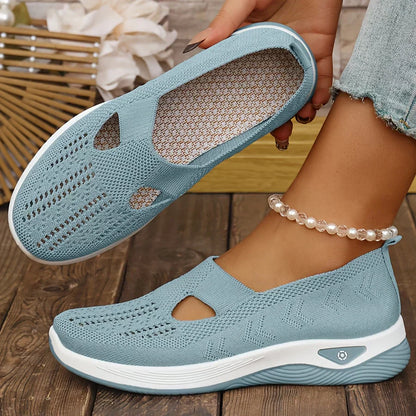 Light blue orthopedic slip-on shoes with knit upper, cutout openings, and white cushioned sole
