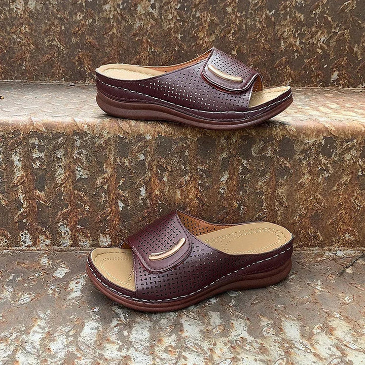 Pair of perforated slip-on sandals: burgundy and light brown with curved straps