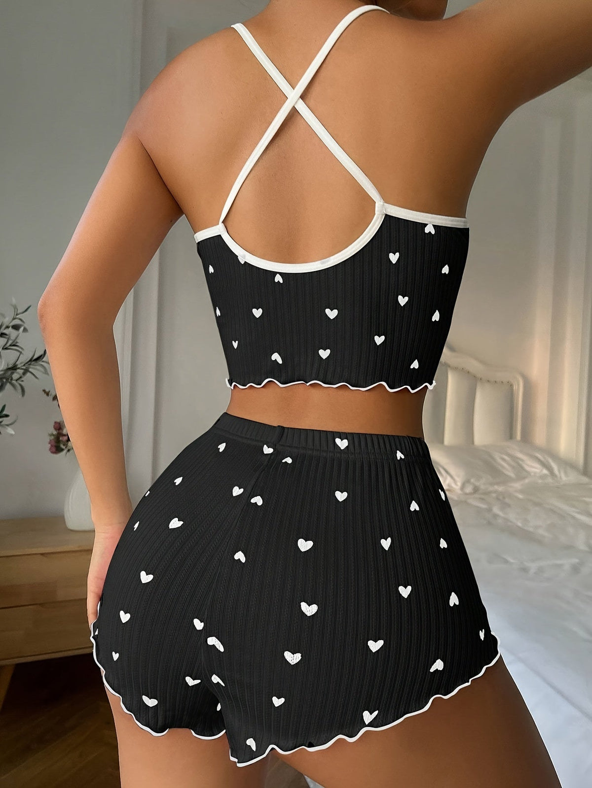 Black heart-print pajama set with ruffle trim, crisscross back straps and matching shorts