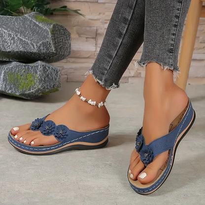 Navy blue orthopedic sandals with flower applique front and cushioned sole