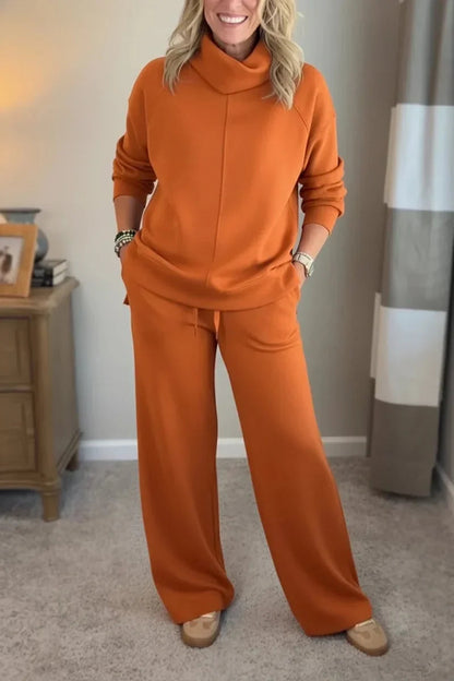 Orange coordinated zip-front hoodie top and wide-leg pants set.