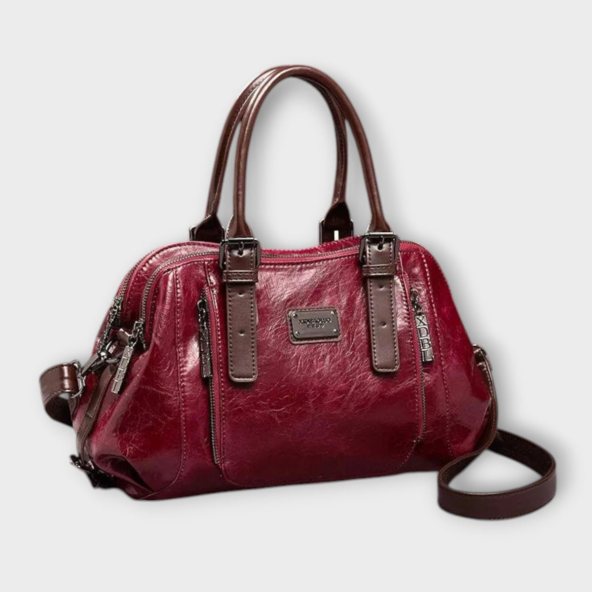 Vintage leather-look shoulder bag in red with top handles, zipper details, crossbody strap