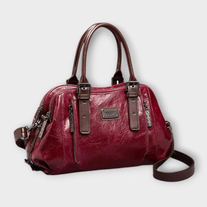 Vintage leather-look shoulder bag in red with top handles, zipper details, crossbody strap
