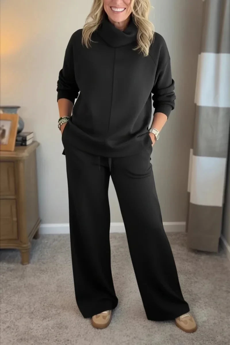 Black coordinated zip-front hoodie top and wide-leg pants set.