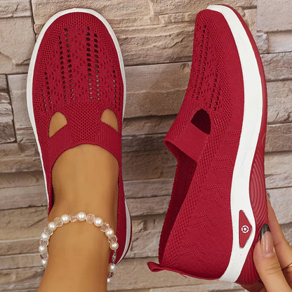 Red orthopedic slip-on shoes with knit upper, elastic collar, and cushioned white outsole