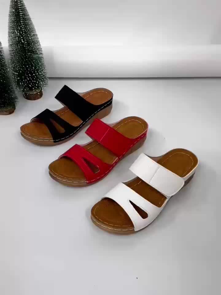 Black, red, and white slide sandals with open toe and cushioned sole