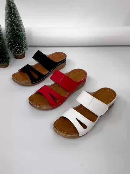 Black, red, and white slide sandals with open toe and cushioned sole