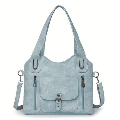 Light blue suede-look shoulder bag with top handles, front flap pocket, and side zippers