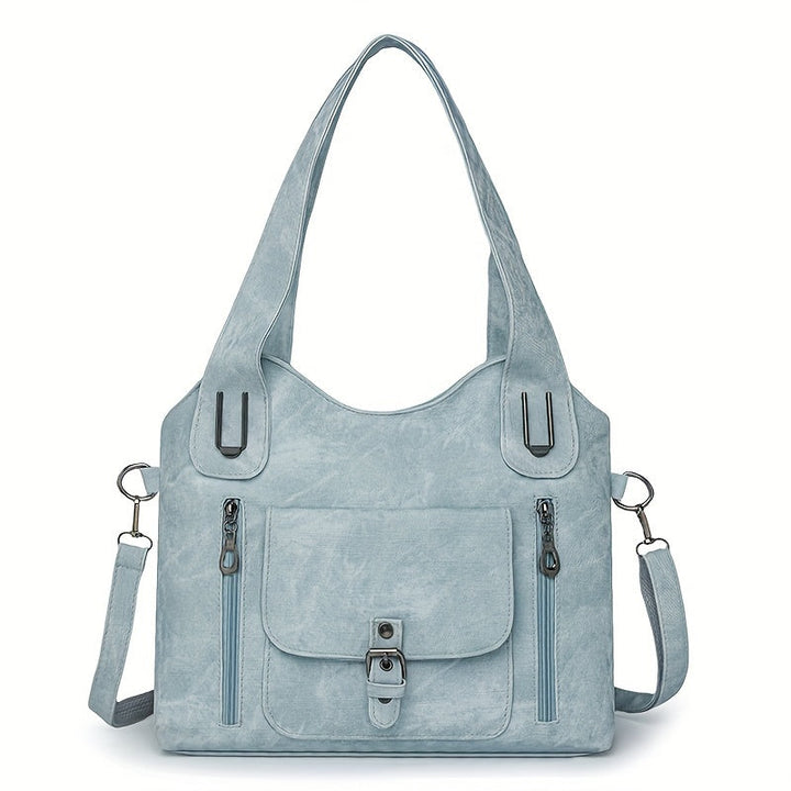 Light blue suede-look shoulder bag with top handles, front flap pocket, and side zippers