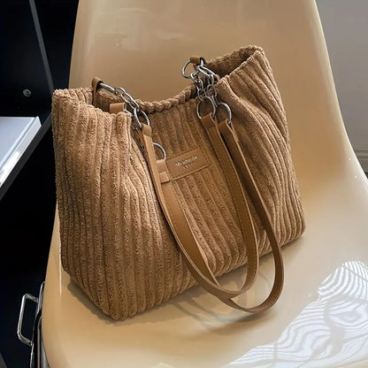 Large capacity corduroy tote bag in tan with top handles, zipper pocket, and wrist strap