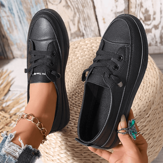 Black lace-up orthopedic sneakers with textured upper and thick rubber sole