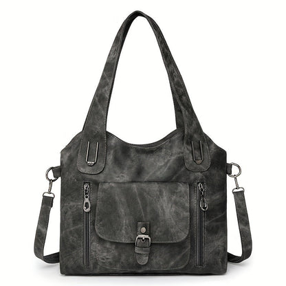 Black suede-look shoulder bag with top handles, front flap pocket, and adjustable shoulder strap