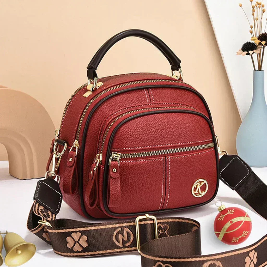 Mini chic crossbody shoulder bag in wine red with gold-tone hardware and zip compartments