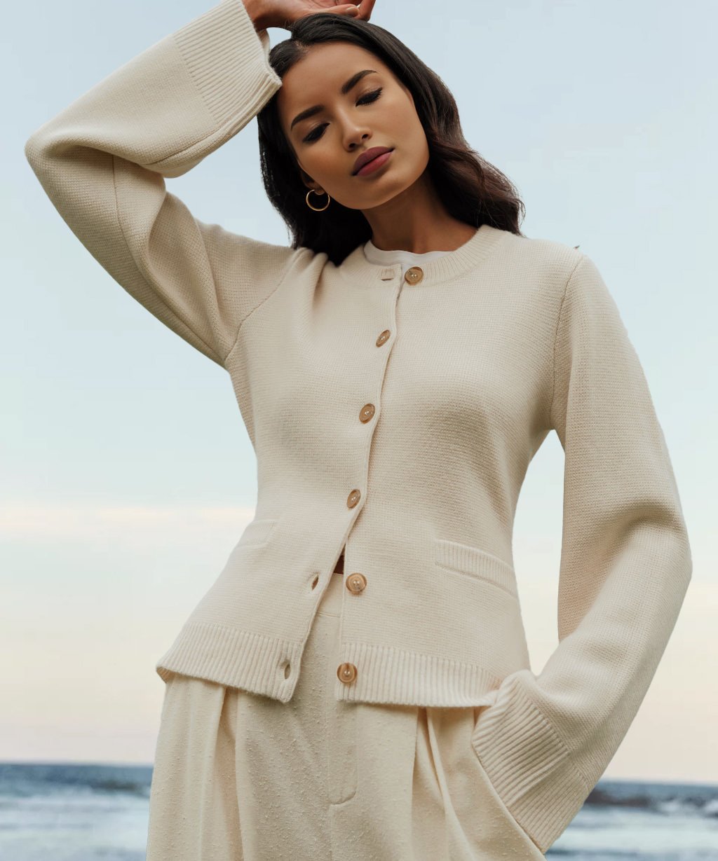 Cream cardigan sweater with button placket and ribbed cuffs