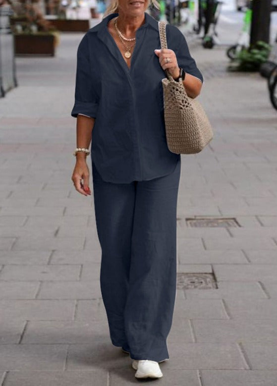 Navy two-piece set: short-sleeve button-up top with wide-leg trousers.