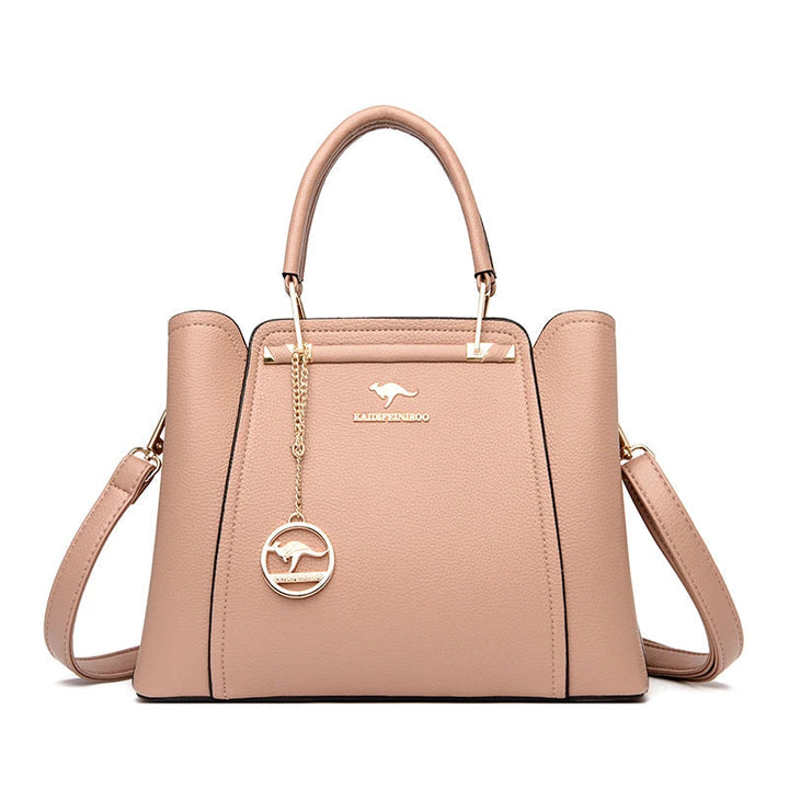 Women’s structured handbag with top handles, shoulder strap, and front panel, beige rose