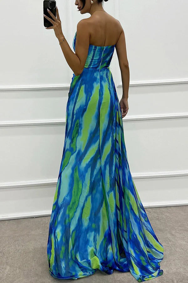 Back view of blue strapless maxi dress with abstract print and floor-length side panels