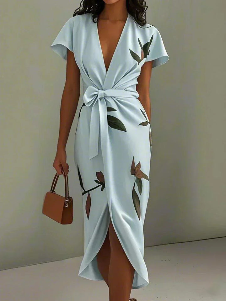 Light blue wrap midi dress with short sleeves, V-neck, leaf print, and bow waist tie