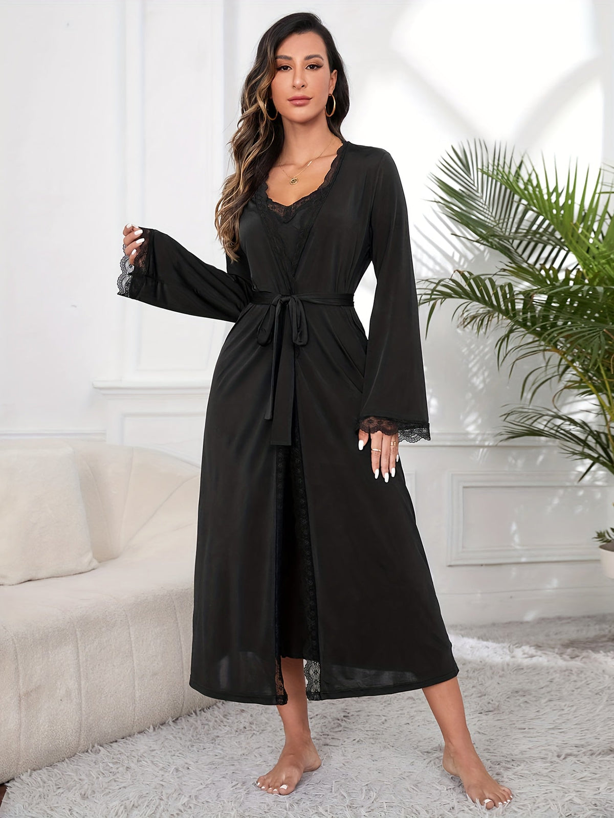 Women's black lace robe set with belted long robe and satin slip dress, front view