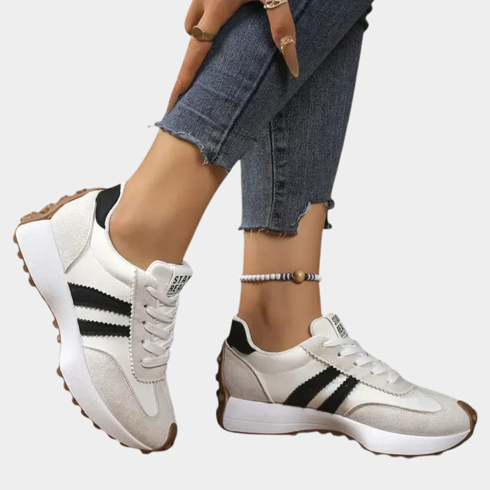 White and gray low-top lace-up orthopedic sneakers with black triple stripes and cushioned sole