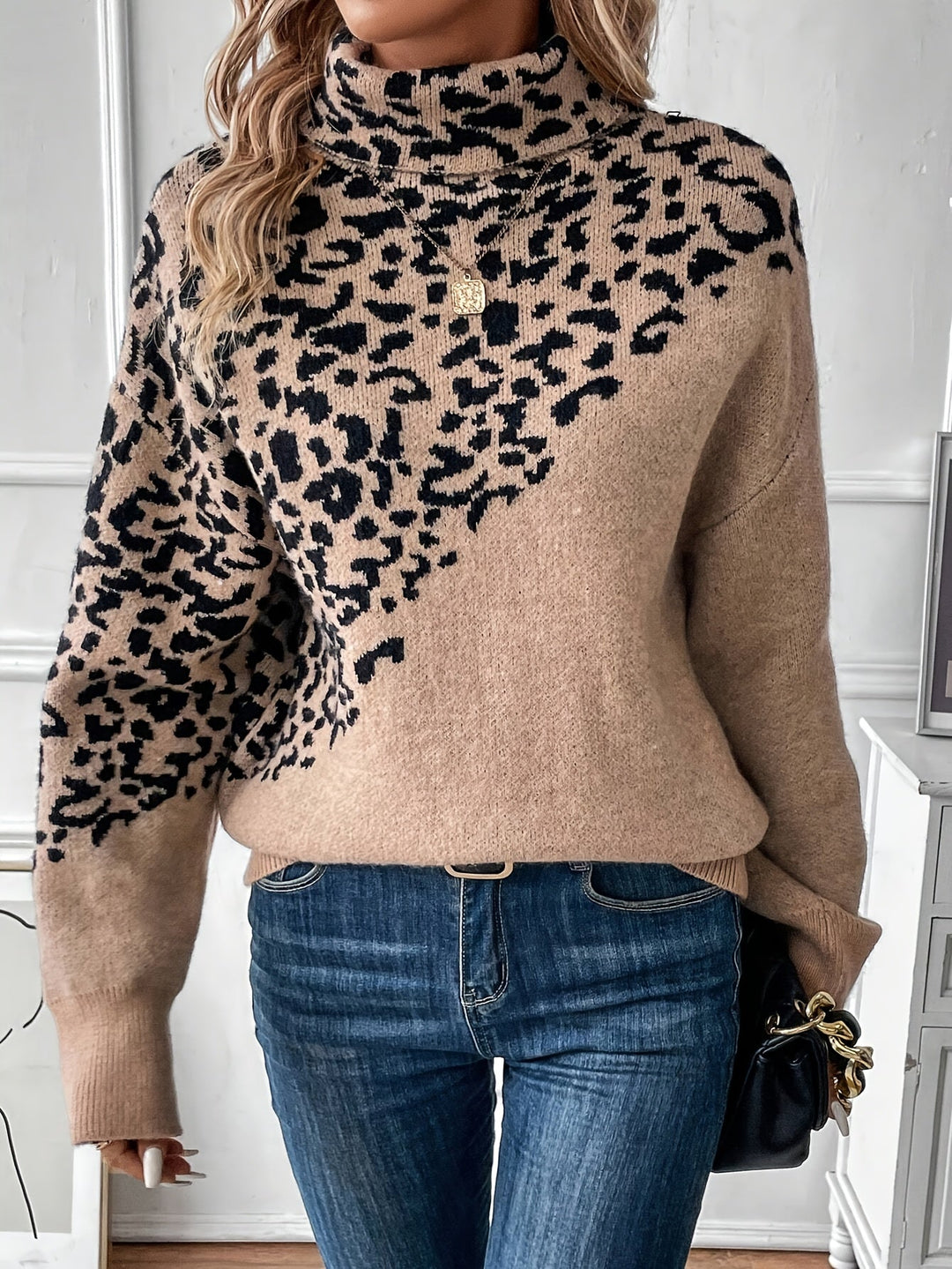 Leopard print knit sweater with tan front, long sleeves, and ribbed cuffs