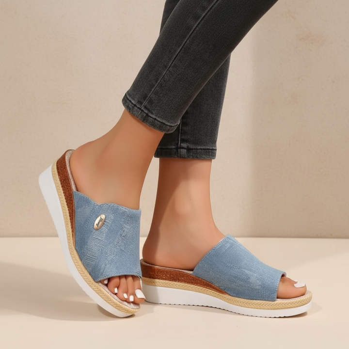 Blue denim ergonomic sandals with open toe and tan espadrille-style sole trim