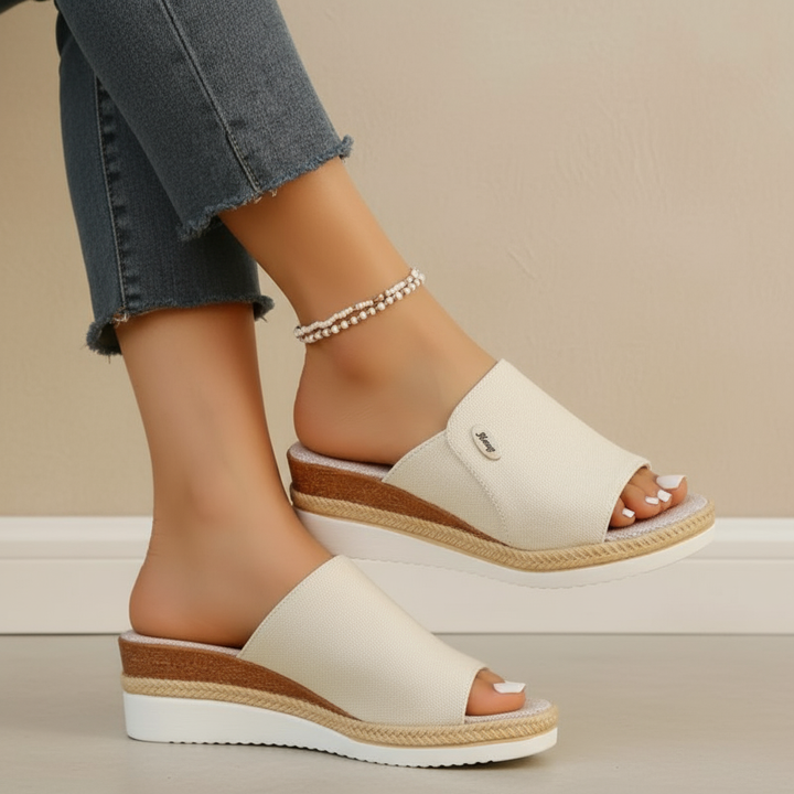 Cream fabric ergonomic sandals with open toe and tan espadrille-style sole trim