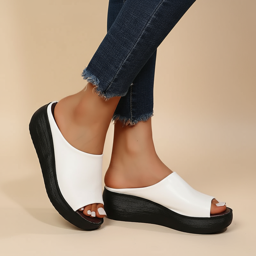 White orthopedic slide sandals with wide open toe and thick black platform sole
