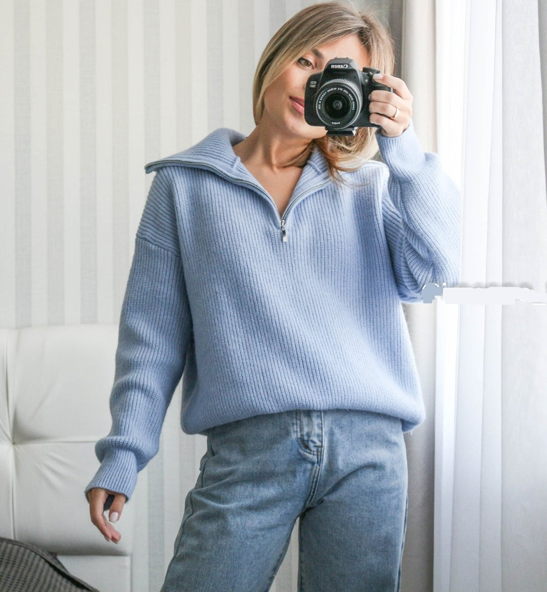Light blue knit half-zip sweater with long sleeves and stand collar, front zipper