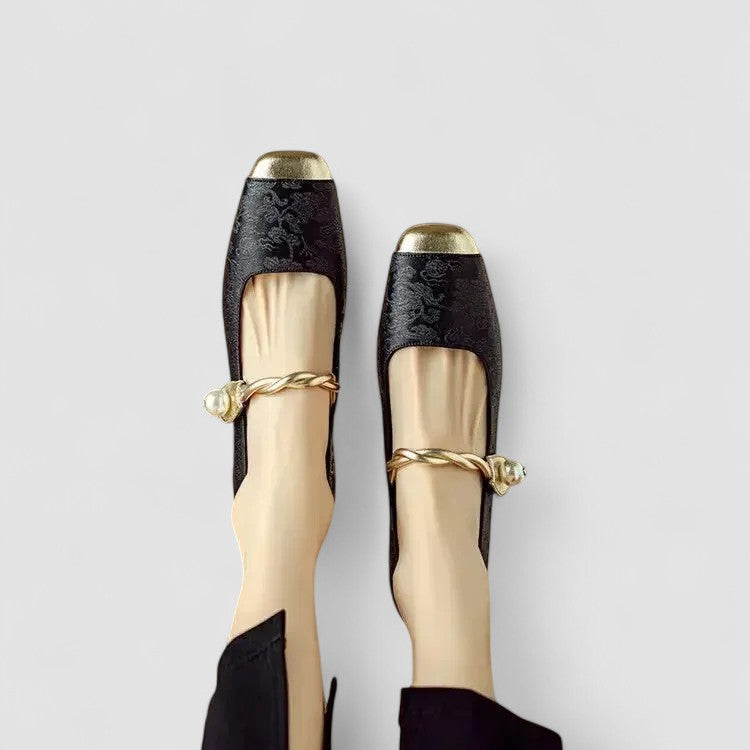 Black orthopedic Mary Jane shoes with gold bow tie and patterned upper trim