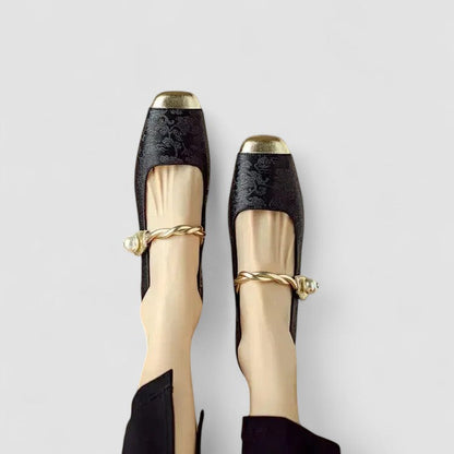 Black orthopedic Mary Jane shoes with gold bow tie and patterned upper trim