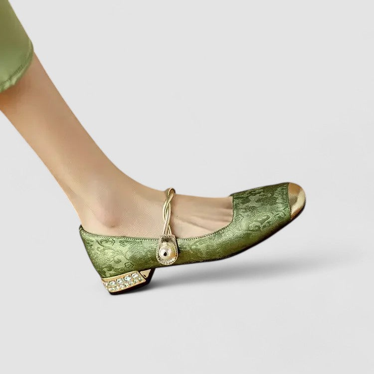 Green orthopedic Mary Jane shoes, side view with gold bow strap and jeweled heel