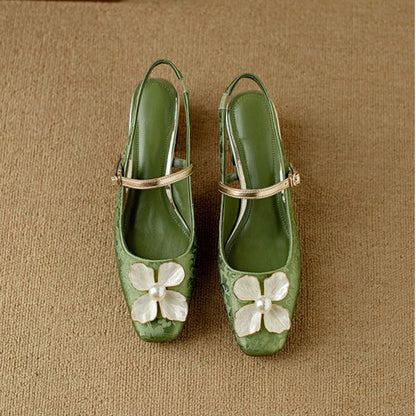 Green slingback pumps pair, pointed toe, ankle strap, floral appliqué on top