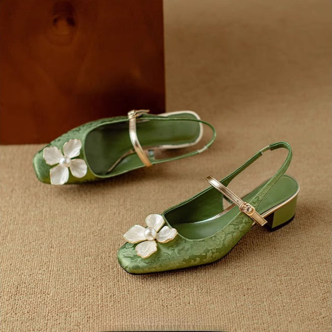 Green Mary Jane pumps with low block heel, white flower applique, and ankle strap