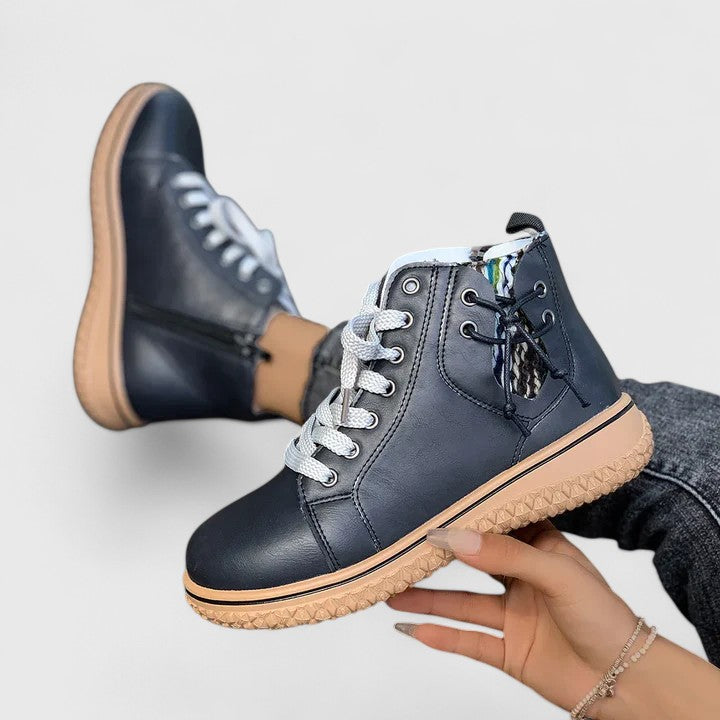 Navy high-cut orthopedic sneaker with lace-up, side zipper, and tan rubber sole