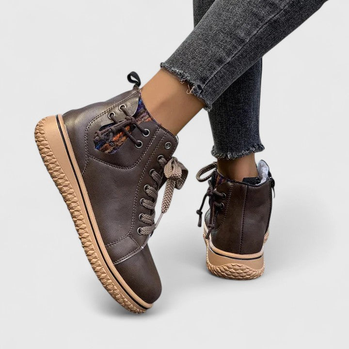 High-cut sneakers in dark brown with black laces and tan textured sole