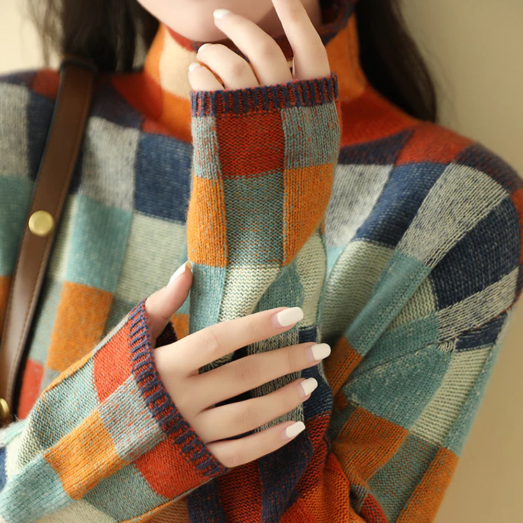 Plaid knit sweater with ribbed collar and long sleeves; textured multicolor square pattern.