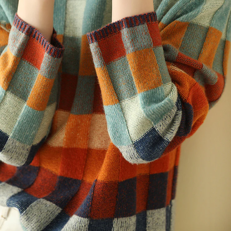 Plaid sweater neckline and sleeve cuff; ribbed knit with multicolor check blocks.