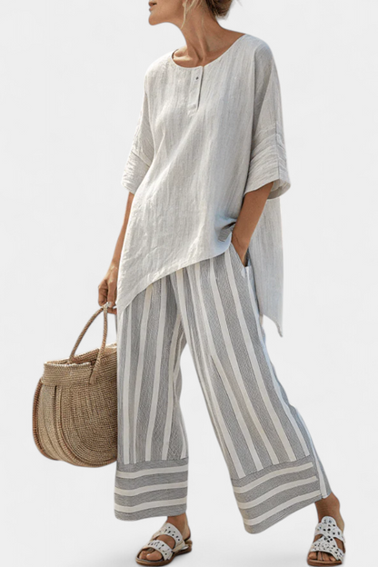 Light white asymmetric blouse with elbow sleeves; gray striped wide-leg trousers