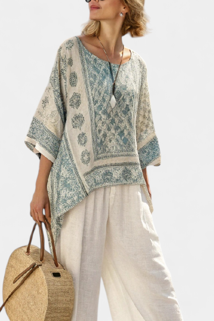 Blue-green printed blouse with elbow sleeves and white wide-leg trousers