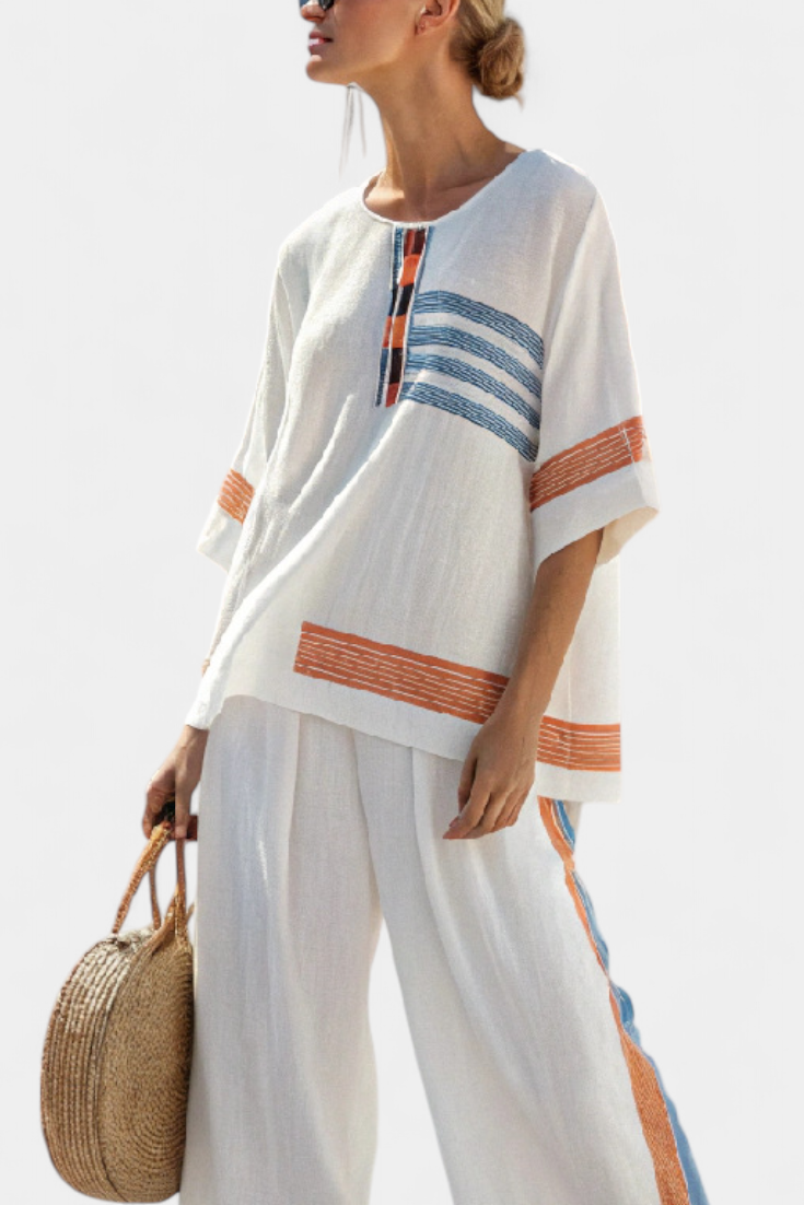White tunic top with orange-and-blue vertical stripe and loose matching trousers