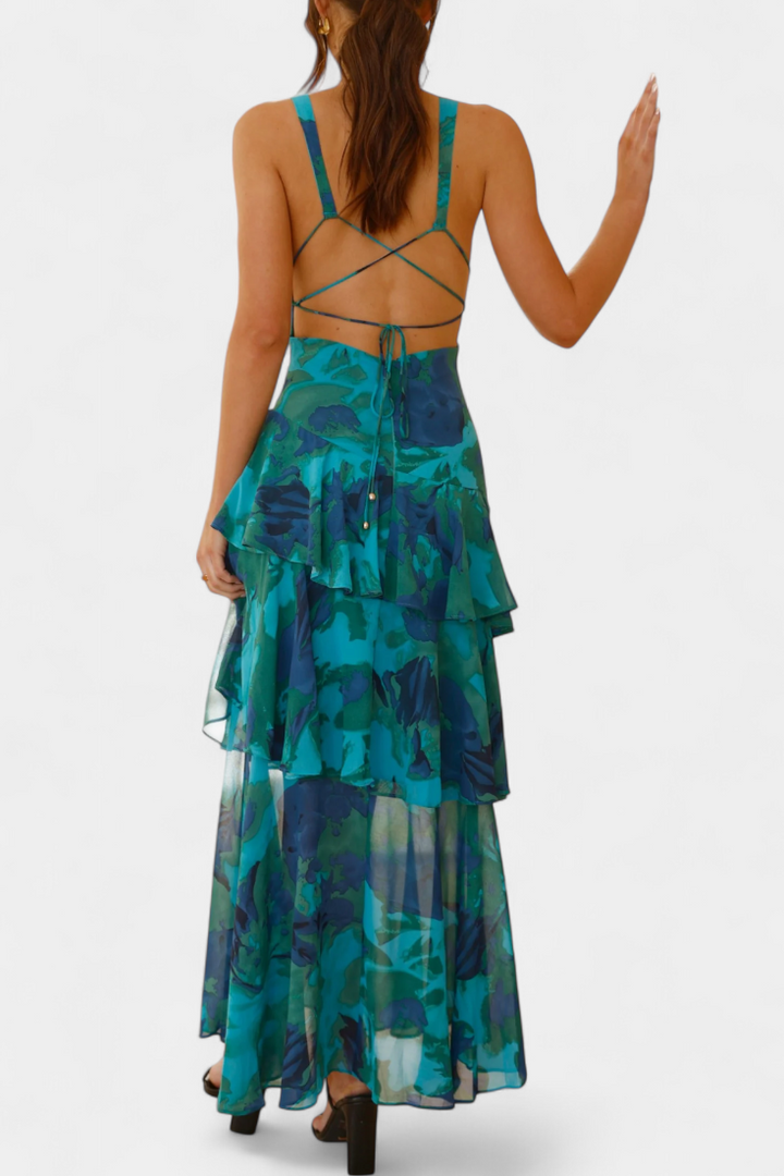Back view of tiered ruffle dress with crisscross straps, teal floral print and open back