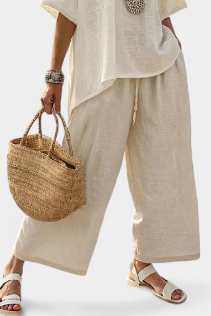 Wide-leg trousers with drawstring waist and side pockets, worn with short-sleeve shirt