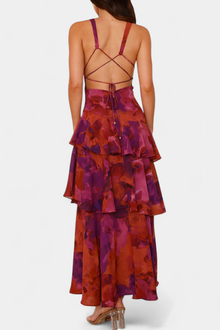 Back view of tiered ruffle dress with crisscross straps, purple and red floral print