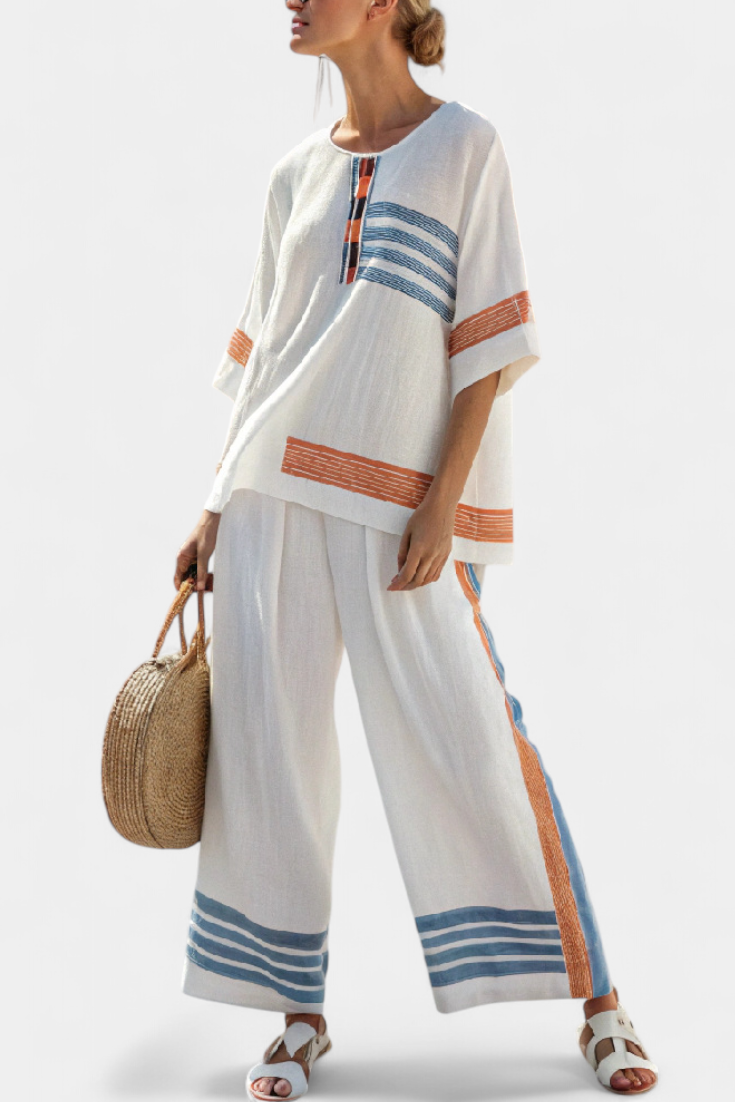 White tunic top with orange-and-blue stripe panels and matching wide-leg trousers