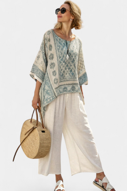Blue-green printed blouse over white wide-leg trousers, wide sleeves
