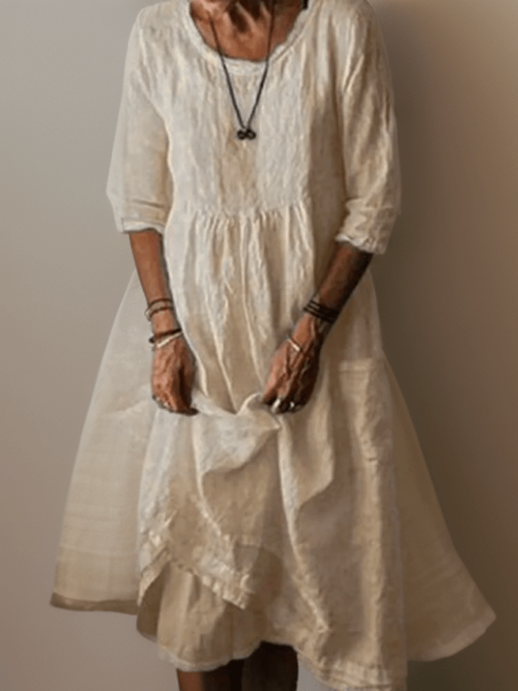 Cream flowing maxi dress with scoop neck, gathered waist, three-quarter sleeves and tiered hem
