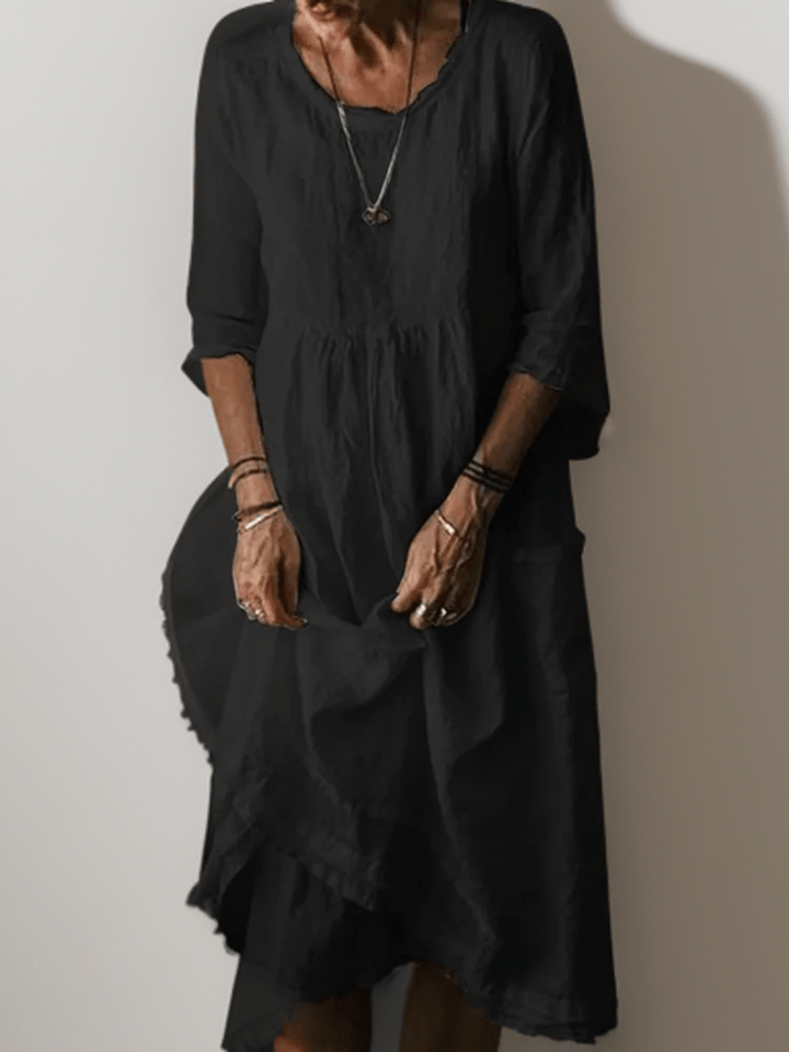 Black flowing maxi dress with scoop neck, gathered waist, three-quarter sleeves and tiered hem