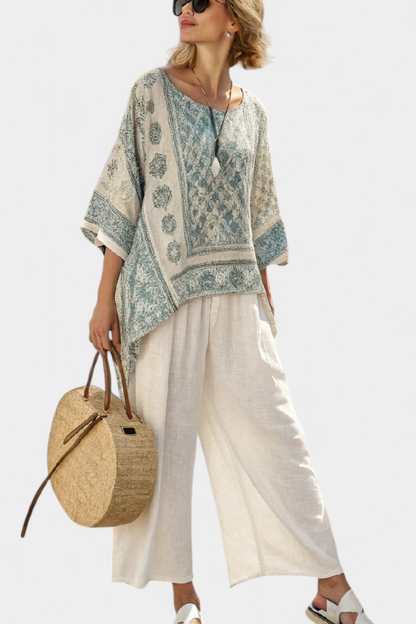 Blue-green printed blouse and white wide-leg trousers, relaxed fit