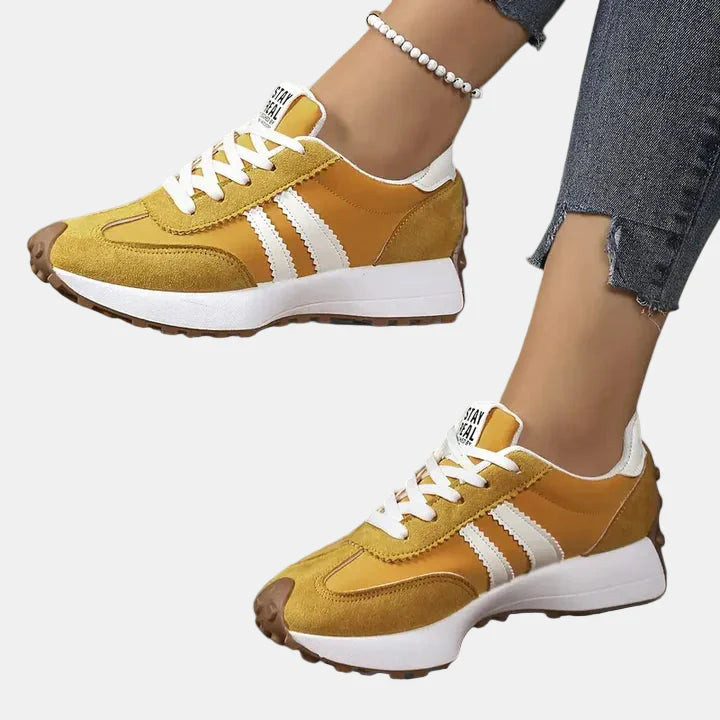 Yellow low-top lace-up orthopedic sneakers with white triple stripes and chunky sole